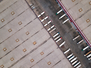 4k Aerial shot of trucks on warehouse parking terminal.