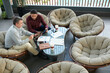 © DragonImages - Senior entrepreneur showing statistics on digital tablet to colleague when they are aving meeting in office lounge area