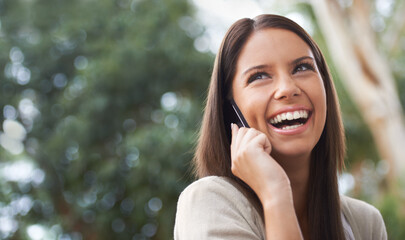 Canvas Print - On the phone to her Best Friend. A pretty young woman enjoying a conversation in the park.