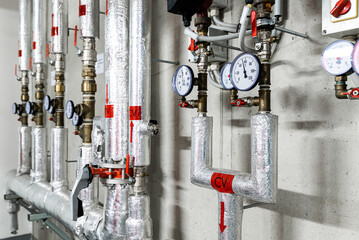 Barometers on pressure pipes, underground premises of the factory with heat and water distribution technology