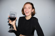 © Seventyfour - Portrait of carefree young woman partying and holding wine glass while looking at camera, shot with flash