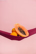 © ChristopherTP - two oranges and a papaya cut in half on a red cloth in front of a peach background as a symbol of the pelvic floor