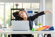 © Bangkok Click Studio - Asian young tired exhausted lazy sleepy female businesswoman secretary employee staff in formal suit sitting take break relaxing resting from working stretching arms relief stress in company office