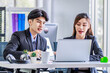 © Bangkok Click Studio - Asian young happy professional male businessman mentor and female businesswoman colleague in formal suit working discussing meeting together at workplace desk with laptop notebook computer in office
