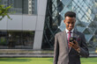 © Ranta Images - Portrait of handsome young African businessman outdoors in city