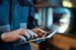 © pressmaster - Hands of contemporary engineer of industrial plant with tablet pointing at screen or scrolling through internet resources for data
