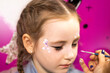 © Nataliia - childrens makeup face paint drawings Girls face painting. Little girl having face painted on birthday party. closed eyes. High quality photo