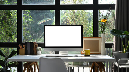 Poster - Front view computer pc, picture frame and office supplies on white table. Blank screen for your graphic display montage.