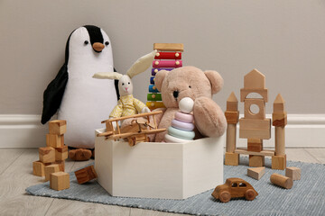 Wall Mural - Set of different toys on floor near beige wall