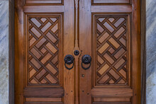 A Carved Wooden Door With Marble Sills And Iron Handles