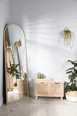 Poster - stylish hallway room interior with wooden commode and large mirror