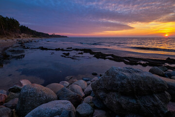 Wall Mural - rocks in the sea at sunset