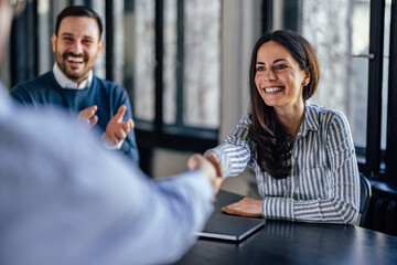 Smiling caucasian woman, happy about the new employee she hired.