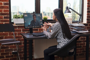 Wall Mural - businesswoman on online videocall conference with team leader regarding management strategy. company
