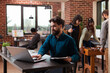 © DC Studio - Busy businessman analyzing marketing statistics working at business project in brick wall startup office. Freelancer man typing company turnover on laptop computer brainstorming ideas