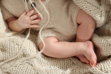 Canvas Print - Top view of adorable newborn baby on knitted plaid, closeup