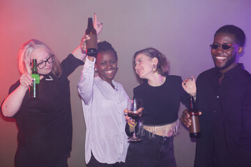 Wall Mural - Hazy shot of diverse people dancing at party against minimal background