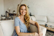 © shurkin_son - Close-up portrait of beautiful happy 50-years-old woman with amazing hairstyle looking at camera and smiling while sitting on sofa. People and lifestyle. Leisure time, hobby. Natural beauty