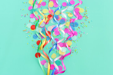 Wall Mural - Party colorful confetti over pastel blue background. Top view, flat lay