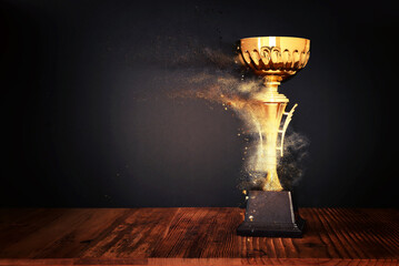 Wall Mural - image of gold trophy over dark background