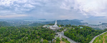 Back And Left Side Of White Buddha Statute With Panorama View Place On Mountain In Southern Part Of Thailand With Cloudy Sky.