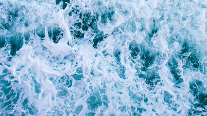 Poster - Top view with waves and bubbles of ocean blue water surface.