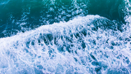 Poster - Top view with waves and bubbles of ocean blue water surface.