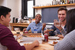 © Marius V/peopleimages.com - Theres pizza for all. Cropped shot of a group of friends enjoying pizza together.