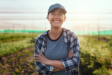 Wall Mural - The farm life is the life for me. Cropped portrait of an attractive young female farmer standing with her arms crossed while working on the farm.