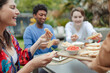© Caia Image - Friends enjoying pita bread and dip on patio