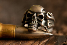 Silver Ring With A Skull And A Bullet On A Wooden Table Macro Photo, Death And Fear And War, Weapons