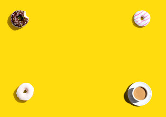 Wall Mural - Donuts and a cup of coffee - overhead view flat lay