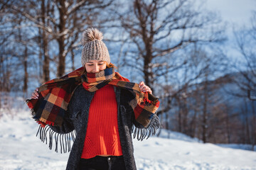 Happy girl in winter clothes portrait snowy outdoor during sunny day