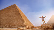 Man tourist walks background of pyramids in Giza Cairo Egypt, sun light travel banner