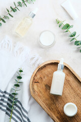 Wall Mural - spa natural organic cosmetics set with eucalyptus branches on stone table in bathroom. flat lay, top