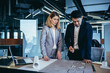 © Liubomir - professional architect designer structural engineer team colleagues working office looking computer screen discussing building plan design project draft drawing. team multiracial business developers