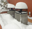 Snow covered heat pumps in winter