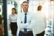 © Camerene P/peopleimages.com - Success is something you need to keep in motion. Portrait of a mature businessman standing in a busy office.