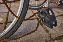 Blue Bike Has Been Outside All Winter And Got Broken. Rusty Bicycle Chain Hangs On Sprocket And Gear.