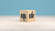Wooden cube with thumbs up and thumbs down symbols