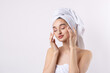 © Mountains Hunter - Beautiful girl with thick eyebrows and perfect skin at white background, towel on head, beauty photo.