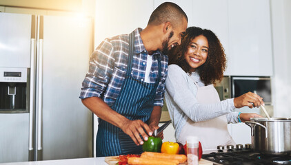 Aufkleber - Cook together to make food better. Shot of a young couple cooking together at home.