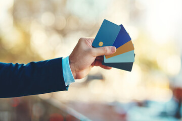 Wall Mural - Theres one to suit your individual needs. Closeup shot of an unidentifiable businessman holding a selection of credit cards.