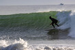 Surfing Rincon point on a big winter swell at sunset