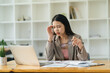 © PaeGAG - Young attractive woman at modern office desk, working on laptop, massaging temples to forget about constant headaches, noisy loud office giving a migraine, relieving stress, chronic pain, help soothe