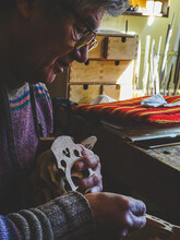 Hispanic Argentine Violin Maker Hands Close Up Choosing A Bridge For A New Cello In His Workshop In Cremona, Italy