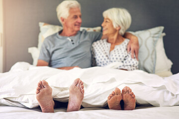 Wall Mural - Waking up next to you is priceless. Shot of a senior couple lying in bed.