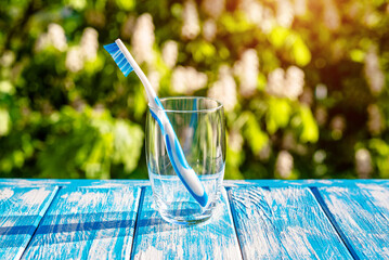 Wall Mural - Toothbrush stands in a glass on a natural background
