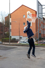 Teenage Boy Scoring Basketball Shot