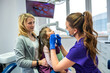 © RomanR - Female dentist examining teeth of little girl at dental clinic